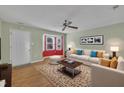Bright living room with hardwood floors, neutral walls, lots of seating, and bay window with natural light at 205 Lizzie King Ct, Willow Springs, NC 27592