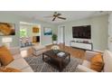 Cozy living room showcasing hardwood floors, a neutral color scheme, and seamless flow into the dining area at 205 Lizzie King Ct, Willow Springs, NC 27592