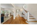Bright foyer with hardwood floors, staircase, and views into the living room offer a warm welcome at 223 Hawthorne Rd, Raleigh, NC 27605