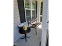 Comfortable seating and table for enjoying the outdoors on the covered front porch at 236 Bragg Ln, Hurdle Mills, NC 27541