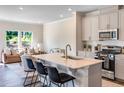 Modern kitchen featuring a quartz countertop island, stainless steel appliances, and an open concept design at 244 Paramount Dr # 24, Smithfield, NC 27577