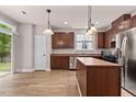 Modern kitchen with stainless steel appliances, wood cabinets and island at 3002 Remington Oaks Cir, Cary, NC 27519
