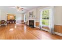 Spacious living room featuring hardwood floors, a fireplace, and large windows with natural light at 306 Holland Rd, Fuquay Varina, NC 27526