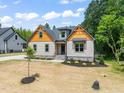 Beautiful home featuring complementary textures and a manicured lawn, inviting curb appeal at 310 Pilot Ridge Rd, Zebulon, NC 27597