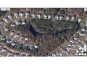 Aerial view of a neighborhood with mature trees and a home with a spacious backyard at 338 Howland Ct, Creedmoor, NC 27522