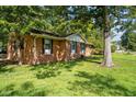 A side view of a single-story brick home with mature trees at 401 Crestview Dr Dr, Durham, NC 27712