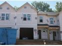 New construction townhome featuring garage, front door and multiple windows ready for finishing touches at 45 Calluna Dr, Clayton, NC 27520