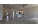 Spacious open-concept living area with modern vinyl floors, recessed lighting, and a kitchen featuring a peninsula at 457 Sweet Potato Lane # 13, Nashville, NC 27856