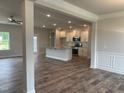 Spacious kitchen featuring white cabinets, a granite island, stainless appliances and hardwood floors at 473 Sweet Potato Lane # 12, Nashville, NC 27856