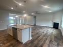 Open-concept kitchen and living room with hardwood floors, granite counters and stainless steel appliances at 473 Sweet Potato Lane # 12, Nashville, NC 27856