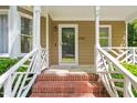 Inviting front porch featuring brick steps and white railings providing curb appeal at 4969 Royal Adelaide Way, Raleigh, NC 27604