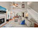 Spacious living room with fireplace, hardwood floors, and staircase with a second floor balcony view at 4969 Royal Adelaide Way, Raleigh, NC 27604