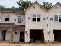 New construction townhome showing the frame, windows, and garage, ready for finishing touches at 51 Calluna Dr, Clayton, NC 27520