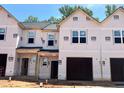 New construction townhomes featuring covered entryways, attached garages, and durable, weather-resistant exterior finishes at 51 Calluna Dr, Clayton, NC 27520