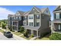 Well-maintained townhome showcases traditional design with landscaped front yards and a modern color scheme at 520 Austin View Blvd, Wake Forest, NC 27587
