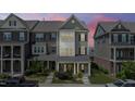 Charming townhome showcasing a beautifully landscaped front yard, neutral siding, and inviting front porch at 520 Austin View Blvd, Wake Forest, NC 27587