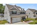 A beautiful two-story home with stone accents, and a cozy front porch with outdoor seating at 528 Brycewood Dr, Burlington, NC 27215