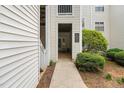 Exterior of a building with walkways to entrances, offering easy access to the units at 6001 Winterpointe Ln # 102, Raleigh, NC 27606
