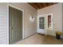 Charming patio with dual doors and a warm welcome mat to unit 102 at 6001 Winterpointe Ln # 102, Raleigh, NC 27606