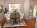 Dining room featuring a large window, chandelier, and table with 6 chairs at 6673 Nc 96 W Hwy, Youngsville, NC 27596