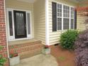 Close up of the front entrance, showcasing the brick steps and decorative leaded glass front door at 6673 Nc 96 W Hwy, Youngsville, NC 27596