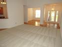 Spacious living room featuring neutral carpet and entryway to dining room at 6673 Nc 96 W Hwy, Youngsville, NC 27596