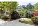 Charming home with well-maintained landscaping, lush trees, and a welcoming driveway at 754 Olde Thompson Creek Ct Rd, Apex, NC 27523