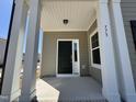 Spacious covered front porch with stately columns and a craftsman-style front door at 773 Portland Rose Dr, Knightdale, NC 27545