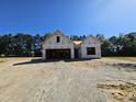 New house under construction featuring modern architectural design with a two-car garage on a sunny day at 79 Mildred Dr, Broadway, NC 27505