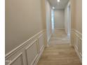 Inviting hallway with decorative wall paneling and wood-look flooring creating a warm and stylish entrance at 79 Mildred Dr, Broadway, NC 27505