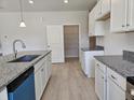 Bright kitchen with white cabinets, granite countertops, and a large pantry for storage at 79 Mildred Dr, Broadway, NC 27505