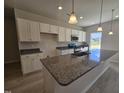 Spacious kitchen features granite countertops, ample white cabinetry, and modern stainless steel appliances at 79 Mildred Dr, Broadway, NC 27505