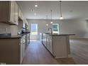 Open kitchen featuring granite countertops, stainless appliances, and an island with a sink at 79 Mildred Dr, Broadway, NC 27505