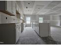 Unfinished kitchen area showcasing ample counter space and natural light from windows at 79 Mildred Dr, Broadway, NC 27505