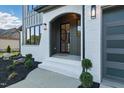 Inviting front entryway features white brick, archway, and a gray door with black hardware at 833 Dunleigh Dr, Burlington, NC 27215
