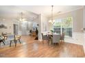 Bright, open-concept living and dining area with hardwood floors and ample natural light at 8437 Whisper Ridge Pl, Raleigh, NC 27613