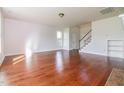 Open living space with hardwood floors, neutral walls, staircase, and natural light at 95 Lockhaven Ct, Cameron, NC 28326