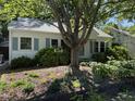 Inviting single-story house with a well-maintained lawn and a beautiful mature tree at 1022 Hale St, Durham, NC 27703