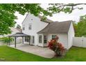 Well-maintained backyard features a gazebo and a beautiful rose bush near the house at 104 Harvolly Dr, Holly Springs, NC 27540