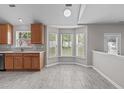 Open kitchen area with tile floors, cozy bay window, and plentiful natural light, perfect for casual dining and entertaining at 104 Harvolly Dr, Holly Springs, NC 27540