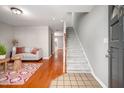 Inviting entryway showcases hardwood floors, staircase, and view into living room at 104 Old Cooper Sq # Bldg J 3, Chapel Hill, NC 27517