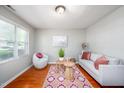 Bright living room features hardwood floors, large window, and comfortable seating area at 104 Old Cooper Sq # Bldg J 3, Chapel Hill, NC 27517