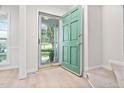 Inviting entryway features a bright green door and light wood flooring at 104 Planetree Ln, Cary, NC 27511