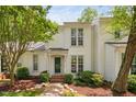 Inviting two-story white house with well-manicured landscaping and traditional details at 104 Planetree Ln, Cary, NC 27511