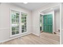 Bright living room with large windows and new laminate floors at 104 Planetree Ln, Cary, NC 27511