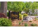 Elegant Paxton neighborhood sign surrounded by beautiful trees and greenery at 104 Planetree Ln, Cary, NC 27511