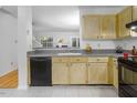 Bright kitchen features neutral counters, backsplash, tile flooring and black appliances at 104 Sir Richard Ln, Chapel Hill, NC 27517