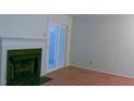 Bright living room features a cozy fireplace, wood floors, and access to outdoor space through sliding glass doors at 104 Sir Richard Ln, Chapel Hill, NC 27517