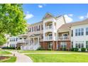 Home exterior featuring a manicured front yard and multiple balconies at 10530 Sablewood Dr # 112, Raleigh, NC 27617