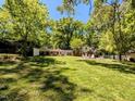 Expansive backyard with lush green lawn and mature trees, ideal for outdoor activities at 107 Forest Rd, Oxford, NC 27565